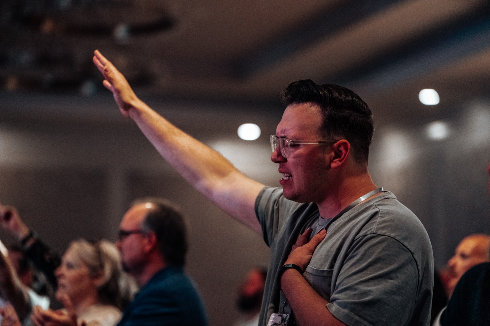 A pastor worshipping with his hand raised